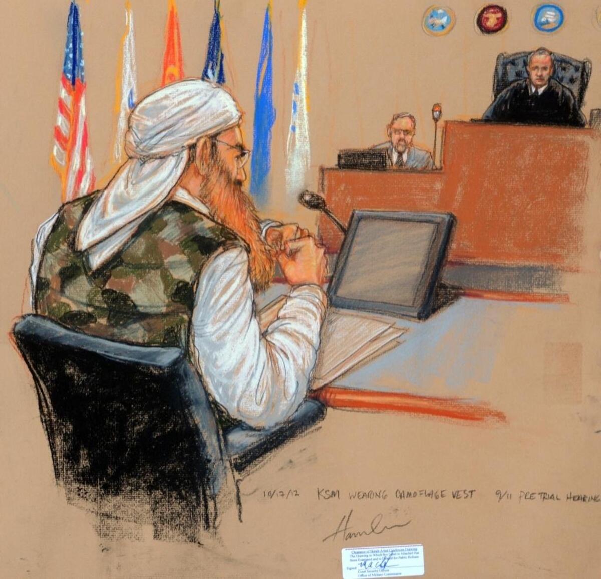 In this sketch by courtroom artist Janet Hamlin, and cleared for release by the Pentagon, Khalid Sheik Mohammed wears a camouflage vest to a Oct. 17, 2012 pretrial hearing at the U.S. Navy base at Guantánamo Bay, Cuba. At far right, Army Col. James Pohl, the judge, sits with a court security officer at his side.