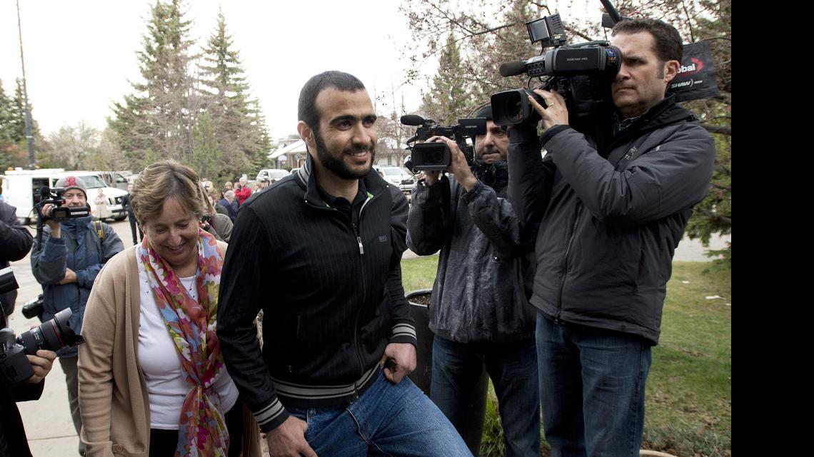 
Omar Khadr walks back to his lawyer's home after speaking to the media in Edmonton, Alberta, Thursday, May 7, 2015. 
