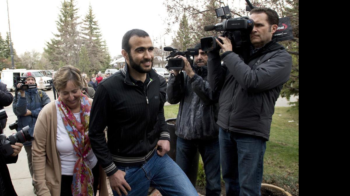 
Omar Khadr walks back to his lawyer's home after speaking to the media in Edmonton, Alberta, Thursday, May 7, 2015. 
