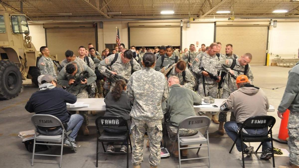 Guardsmen assigned to the 270th Military Police Company, California Army National Guard, and the 38th Military Police Company, Indiana Army National Guard, turn in their weapons at Fort Bliss after arriving Dec. 15, 2015, after a nine-month deployment at Guantánamo.