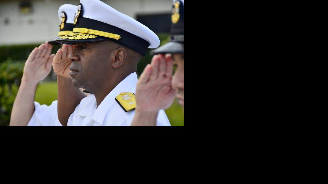 
Rear Adm. Frank Ponds, center, commander of Navy Region Hawaii and Naval Surface Group Middle Pacific, salutes the national ensign during morning colors on Joint Base Pearl Harbor-Hickam, March 19, 2013.
