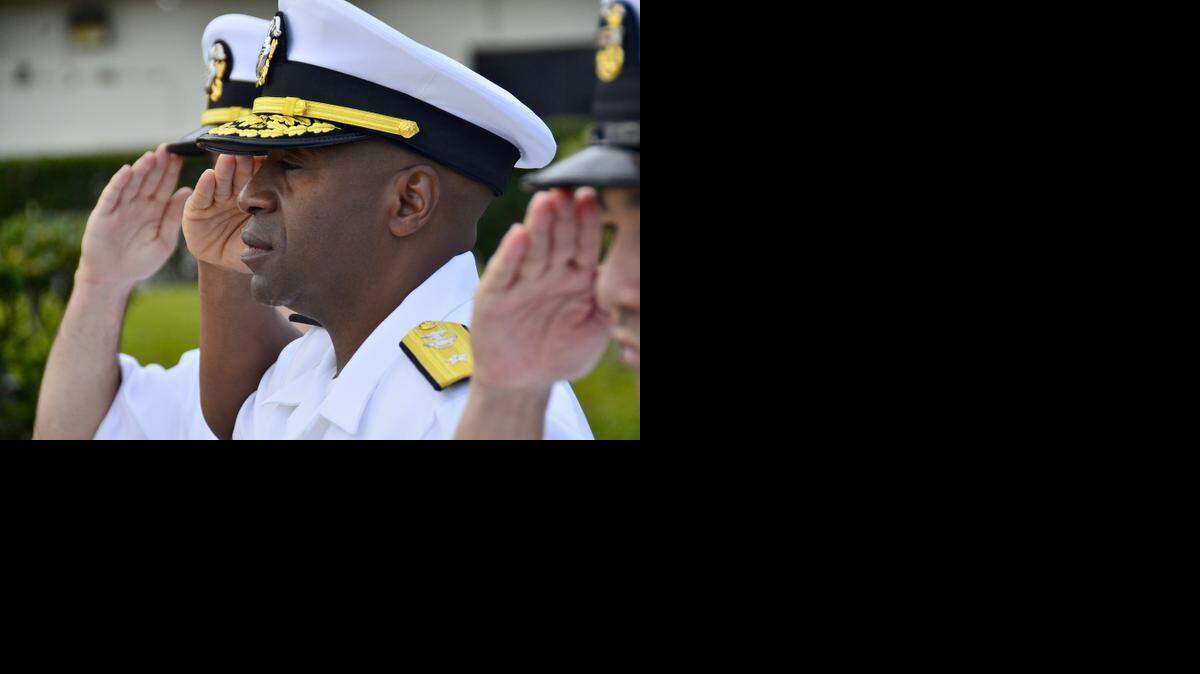 
Rear Adm. Frank Ponds, center, commander of Navy Region Hawaii and Naval Surface Group Middle Pacific, salutes the national ensign during morning colors on Joint Base Pearl Harbor-Hickam, March 19, 2013.
