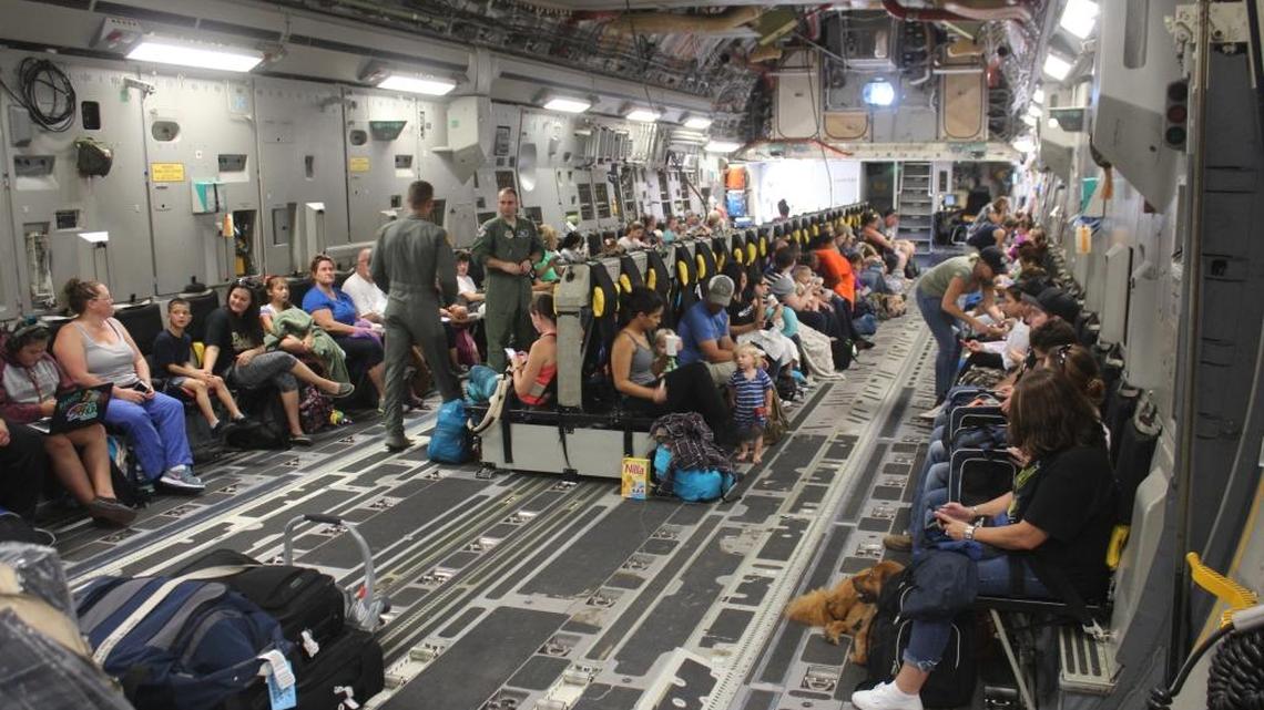 Families settle into their seats aboard a cargo plane for evacuation from Guantanamo Bay ahead of Hurricane Matthew. Approximately 700 spouses and children were evacuated to Naval Air Station Pensacola, Fla.