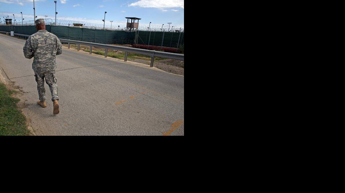 A soldier walks by Camp Delta (no longer holds detainees) at the U.S. Navy base at Guantanamo Bay, Cuba, on Tuesday, Nov. 4, 2014 in this photo approved for release by the U.S. military.