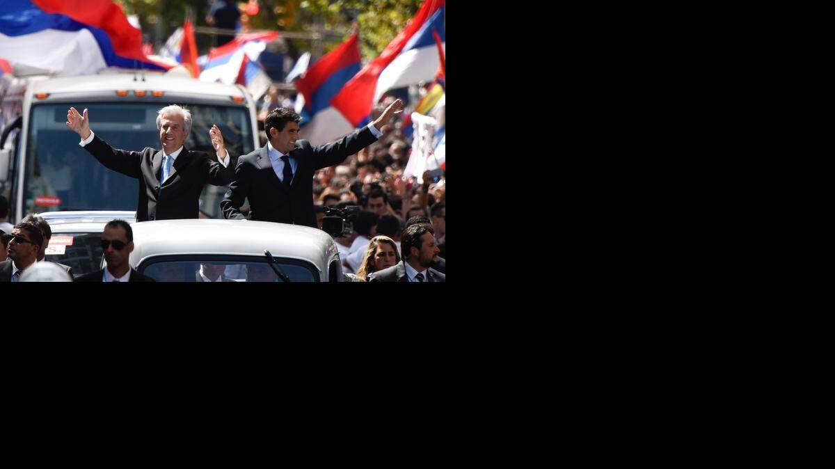 
Uruguay’s President Tabaré Vázquez, left, and the vice president Raúl Sendic wave to the crowd after their March 1, 2015 swearing-in ceremony in Montevideo.
