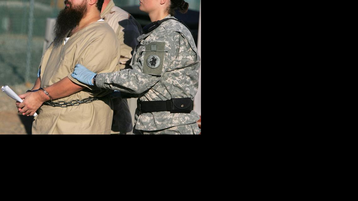 
A female guard escorts a belly-chained detainee from his annual Administrative Review Board hearing in Camp Delta at the U.S. Navy base, Guantánamo Bay, Cuba on Dec. 6, 2006 in a photo approved for release at the time by the U.S. military.
