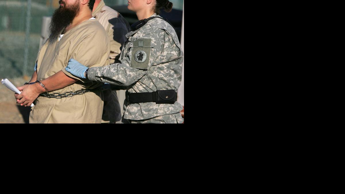 
A female guard escorts a belly-chained detainee from his annual Administrative Review Board hearing in Camp Delta at the U.S. Navy base, Guantánamo Bay, Cuba on Dec. 6, 2006 in a photo approved for release at the time by the U.S. military.
