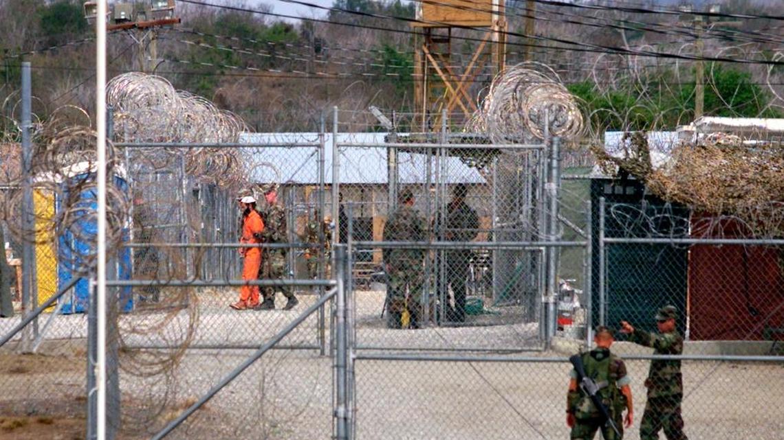 Troops move a detainee inside the Guantánamo detention center called Camp X-Ray on April 3, 2002.