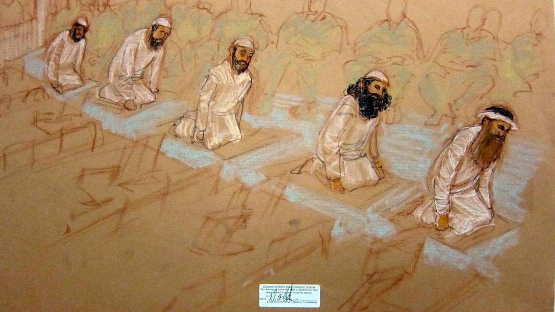 From left, Mustafa al Hawsawi, Ammar al Baluchi, Ramzi bin al Shibh, Walid bin Attash and Khalid Sheik Mohammed pray at their Guantánamo war court arraignment on Saturday, May 5, 2012. This sketch was reviewed and approved for release by a U.S. military security official.