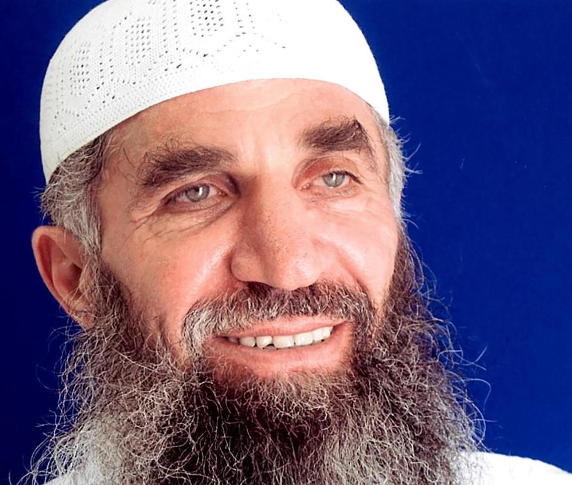 Guantánamo prisoner Abd al Hadi al Iraqi, who says his true name is Nashwan al Tamir, poses for the International Red Cross in a 2014 photo taken for his family, and provided by his attorneys.