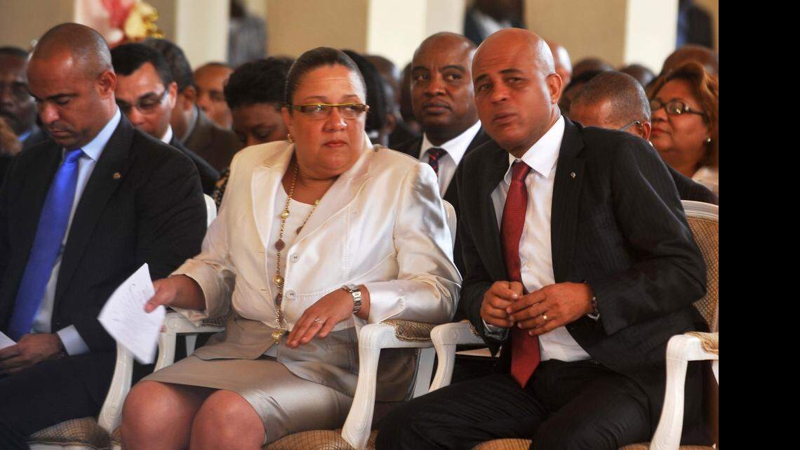 
Haitian President Michel Martelly confers with his wife Sophia Martelly during ceremonies marking Haiti's 209th year of independance from France in 1804, in the northern city of Gonaives on January 1, 2013. The first lady has filed to run for a Senate seat.


