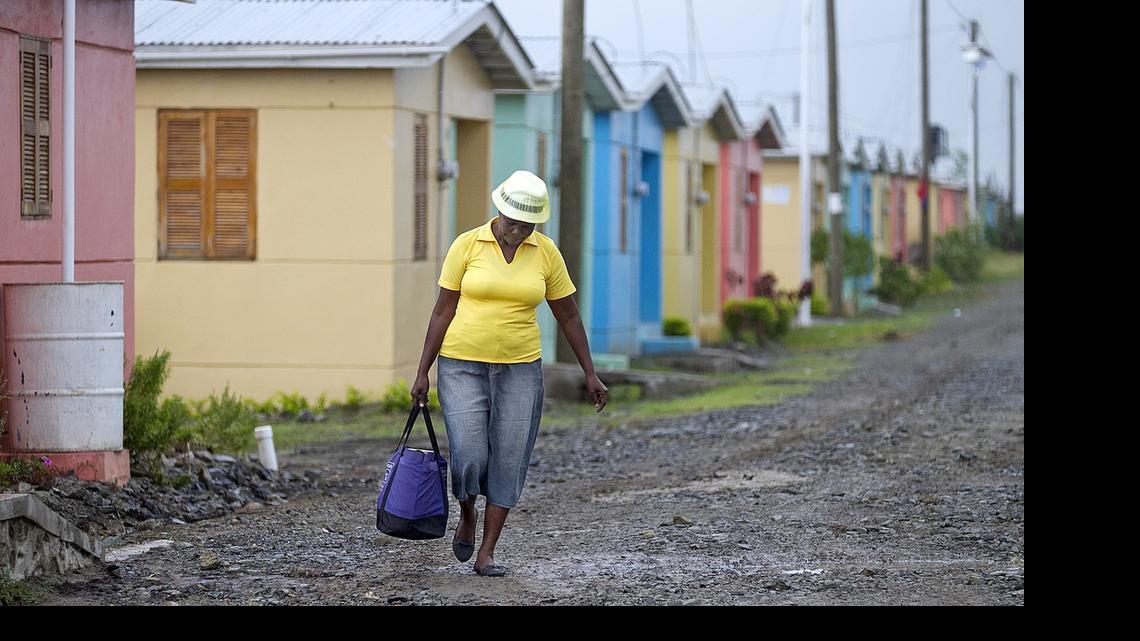
A woman walks through the Caracol-EKAM housing development built by the U.S. Agency for International Development. 
