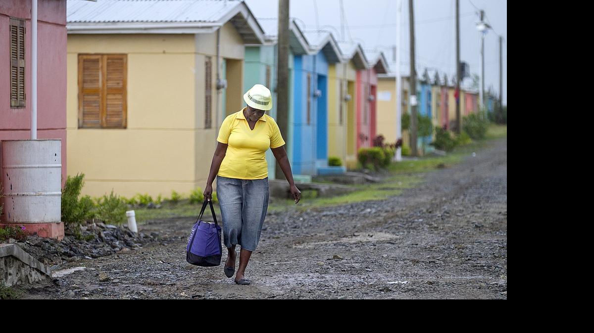 
A woman walks through the Caracol-EKAM housing development built by the U.S. Agency for International Development. 
