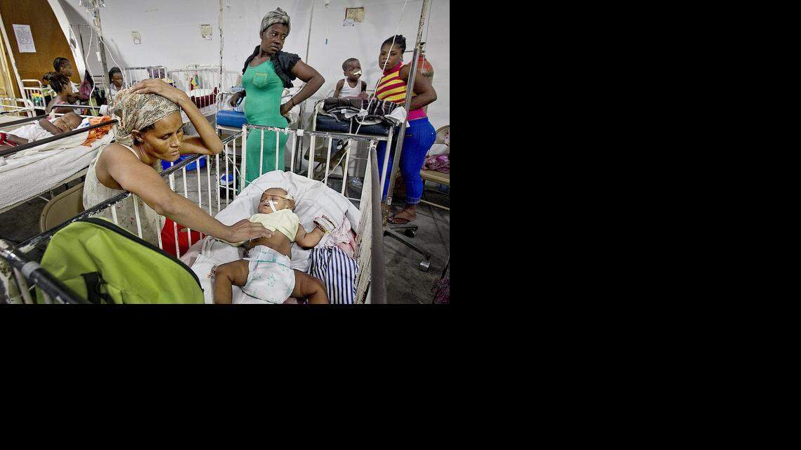 
PEDIATRIC CARE: Yno Bertrand keeps a watchful eye over her infant daughter Carme-Suze Philippe inside a tent doubling as the pediatric ward of Haiti's main and largest public hospital in Port-au-Prince, the Hospital of the State University of Haiti. 
