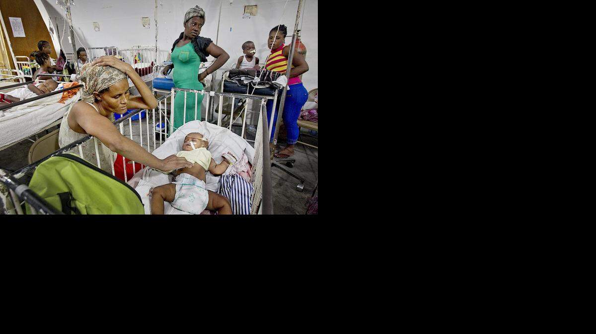 
PEDIATRIC CARE: Yno Bertrand keeps a watchful eye over her infant daughter Carme-Suze Philippe inside a tent doubling as the pediatric ward of Haiti's main and largest public hospital in Port-au-Prince, the Hospital of the State University of Haiti. 
