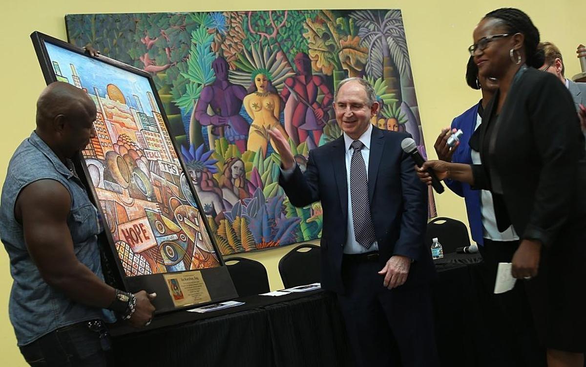 Attorney Ira Kurzban, center, was honored by Haitian community leaders during a community meeting with a group of immigration attorneys in Little Haiti Friday morning.