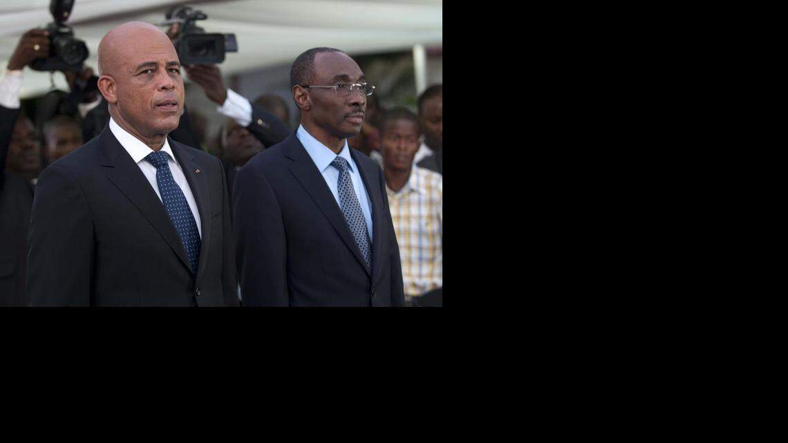 
 Haitian President Michel Martelly (L) stands with Prime Minister Evans Paul before the speech to the nation at the National Palace in Port-au-Prince. 
