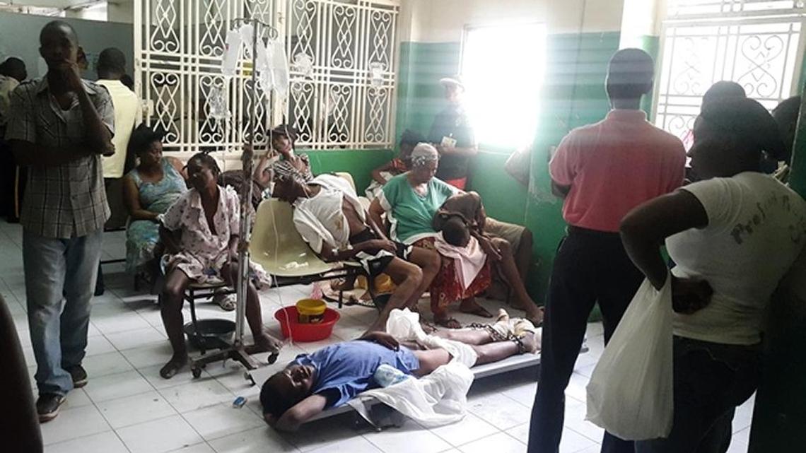 Patients crowd the lobby of Haiti’s General Hospital where a recent outbreak of alcohol poisoning has lead to 21 confirmed deaths at the facility.