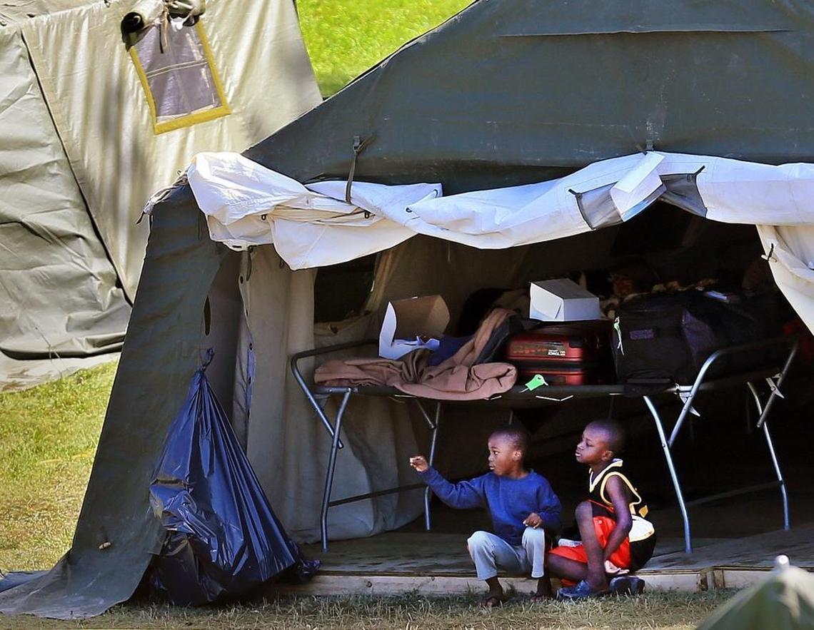 Children sit together at the border migrant camp at St. Bernard-de-Lacolle in Quebec, Canada. Among the migrants are Haitians who were worried that their Temporary Protected Status in the U.S. could soon end under the Trump administration.