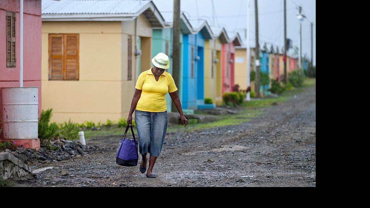 
Signs of progress: A woman walks through the Caracol-EKAM housing development built by the U.S. Agency for International Development. 
