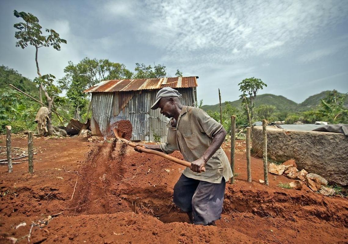One of several men working on a site just off the desolated highway leading into the Grand’Anse. With its cement blocks and clay-colored mud, the construction site was an oddity in a region, where despite shiny new aluminum roofs dotting the once more green landscape, most homes remain in disrepair, their inhabitants living with family and friends.