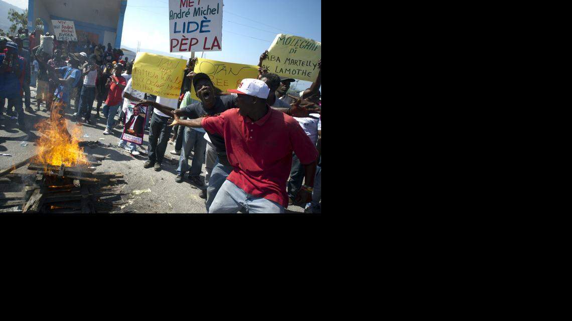 
Demonstrators protest against the government of Haiti President Michel Martelly in Port-au-Prince on Friday, Nov. 28, 2014. Protesters marched through the streets calling for the resignation of the Haitian leader.
