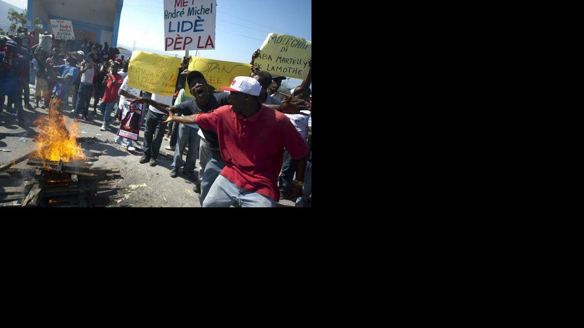 
Demonstrators protest against the government of Haiti President Michel Martelly in Port-au-Prince on Friday, Nov. 28, 2014. Protesters marched through the streets calling for the resignation of the Haitian leader.

