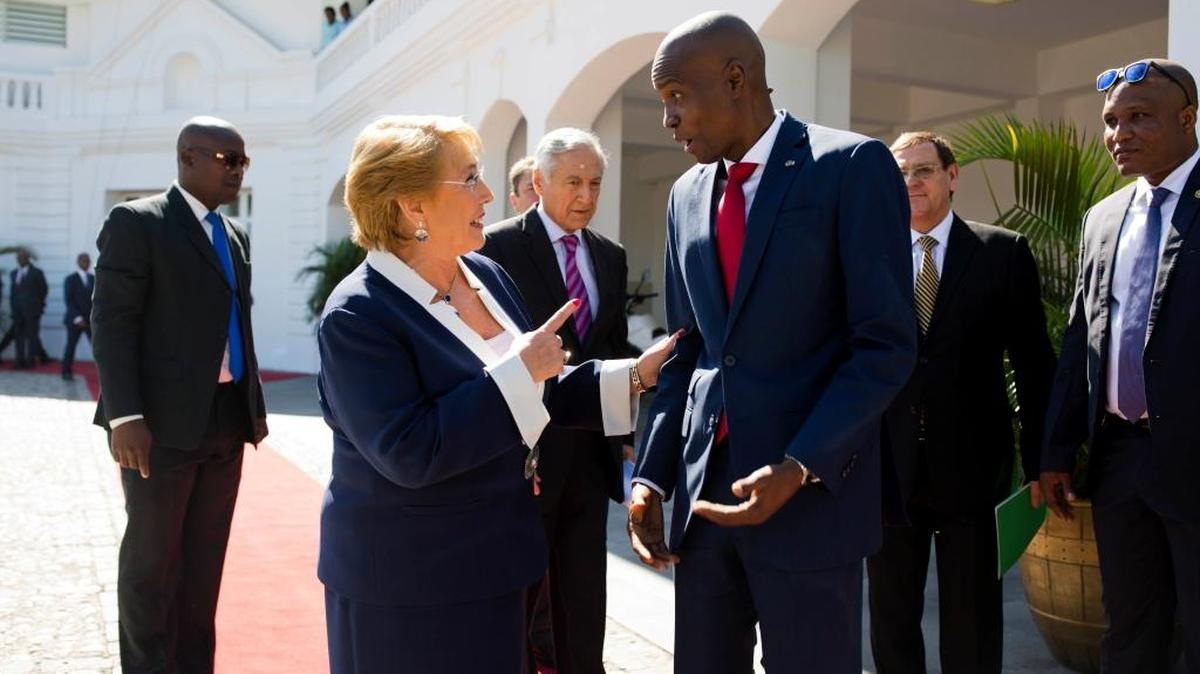 Haiti's President Jovenel Moise, right, talks with Chile's President Michelle Bachelet as she leaves the National Palace after their meeting in Port-au-Prince, Haiti, on Monday, March 27, 2017.