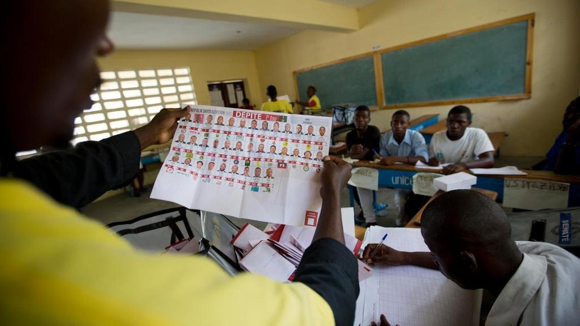 
In this Aug. 9, 2015 file photo, election officials count votes during parliamentary elections in Port-au-Prince, Haiti. 
