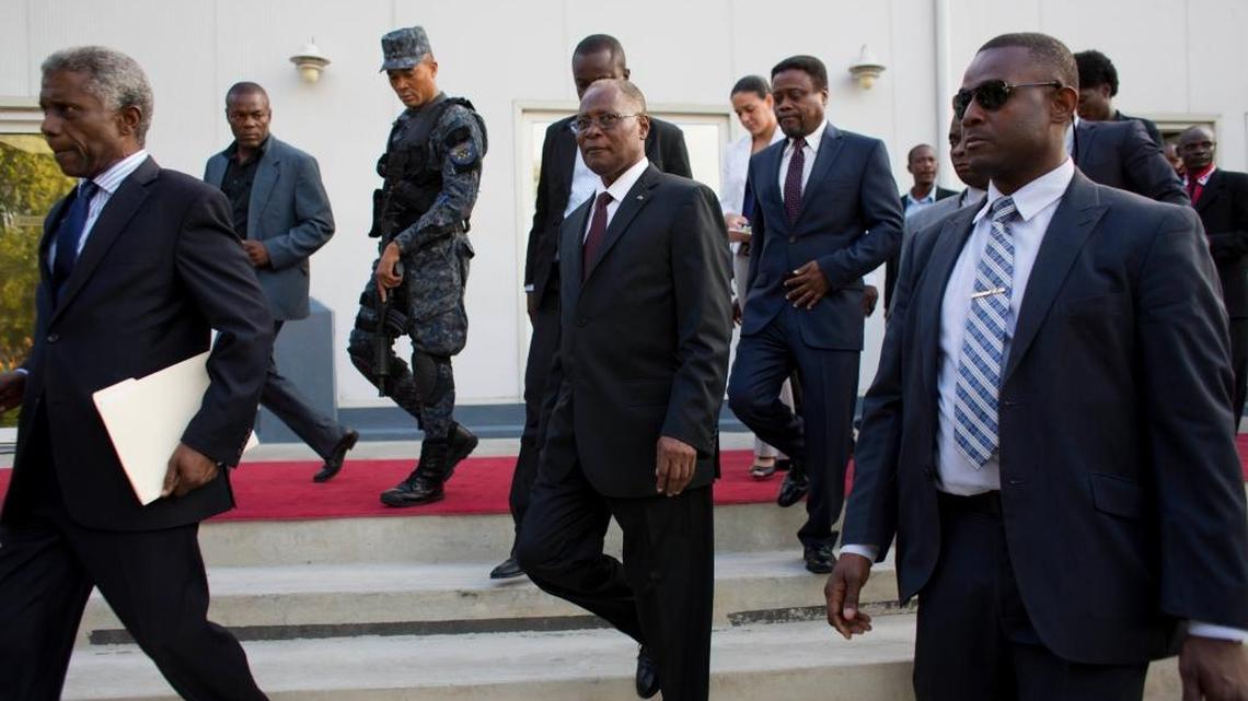 Haiti's interim President Jocelerme Privert, center, arriving with new interim Prime Minister Fritz Jean, behind right, on Feb. 26 for Jean’s induction ceremony at the National Palace in Port-au-Prince, Haiti. Jean, an economist and former governor of Haiti's central bank, was rejected by the Lower Chamber of Deputies on March 20.