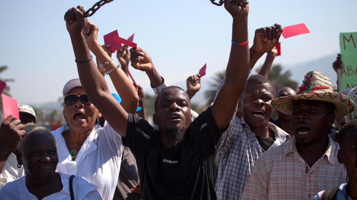 Demonstrator chant anti-government slogans during a protest against the installation of the Haitian parliament in Port-au-Prince, Haiti, Monday, Jan. 11, 2016. Campaigning for Haiti's presidential runoff election has kicked off, though it appears there is only one candidate who will actively participate. This time around, second place finisher Jude Celestin rejected the first-round results as a "ridiculous farce" and his Group of Eight opposition alliance is calling for a transitional government to organize a "fair" election.