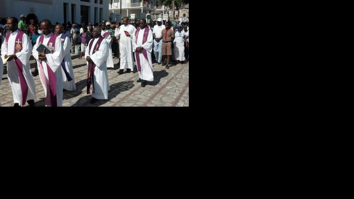 
The Archbishop of Cap-Haïtien, Bishop Max Leroy Mesidor, joins other priests, nuns and parishioners in a silent march last month in Haiti’s second-largest city to protest more than two dozen attacks against religious communities across the country. 
