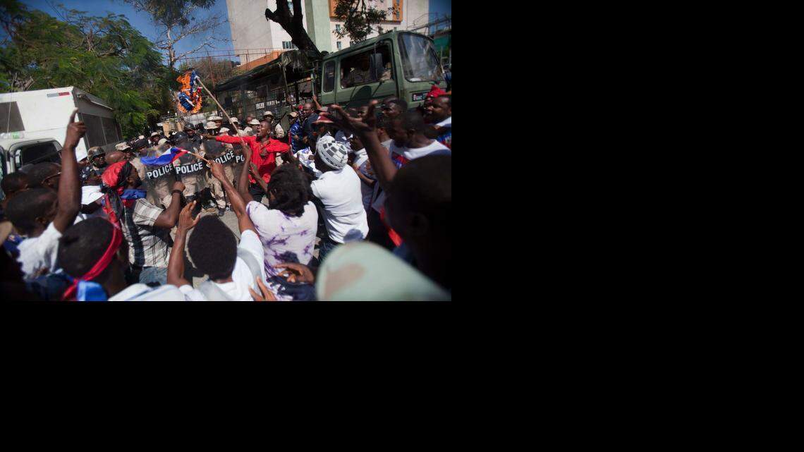 
Protesters burn a Dominican flag in front of the country's consulate during an anti-Dominican Republic protest in Port-au-Prince, Haiti, Wednesday, Feb. 25, 2015. Protesters outraged over a Feb. 11 lynching of a young man of Haitian descent in the Dominican city of Santiago are demanding the neighboring country respect the human rights of Haitians. 


