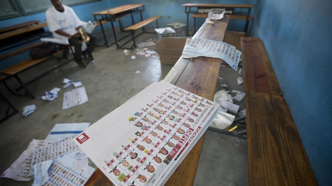 
A man sits inside a voting center after it was closed due to violence, during parliamentary elections in Port-au-Prince, Haiti, Sunday, August 9, 2015. 

