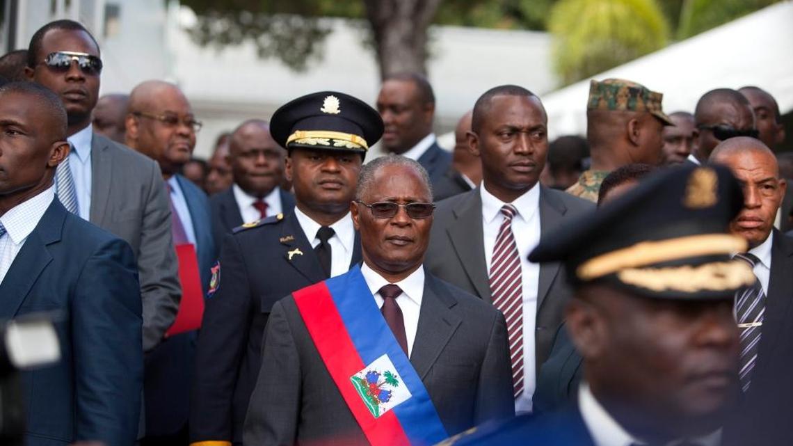 Haiti’s provisional President Jocelerme Privert listens to the national anthem after delivering his speech at an installation ceremony, in Port-au-Prince, Haiti, Sunday, Feb. 14, 2016. Haitian lawmakers have chosen Privert, the country’s former Senate chief to lead a caretaker government that will fill the void left by the recent departure of ex-President Michel Martelly.