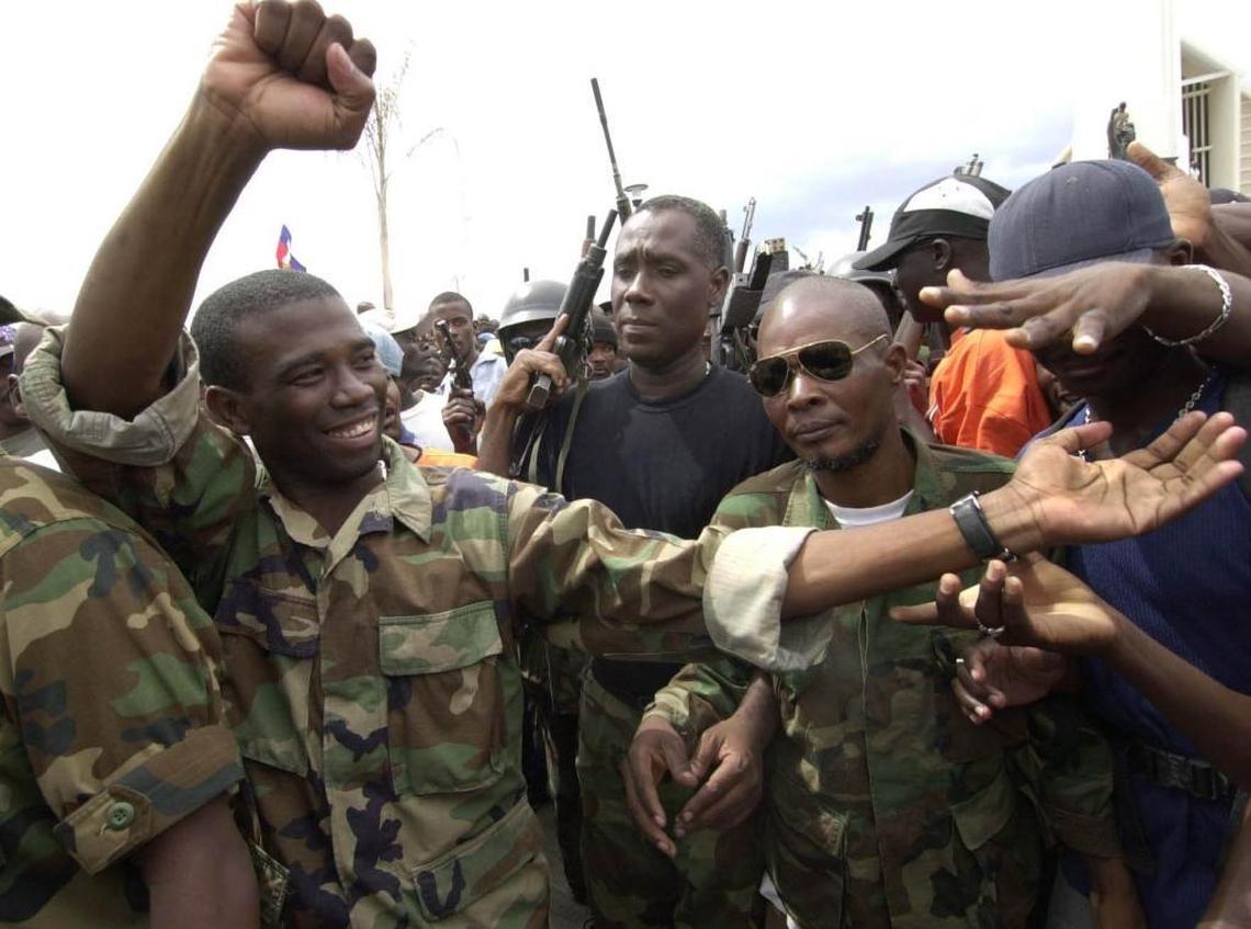 Guy Philippe, left, one of the rebel leaders of the Resistance Front, was in Gonaives after an armed revolt in 2002. Philippe was arrested in 2017 by DEA agents and Haiti’s anti-drug brigade outside of a Port-au-Prince radio station on drug-trafficking charges in the United States.
