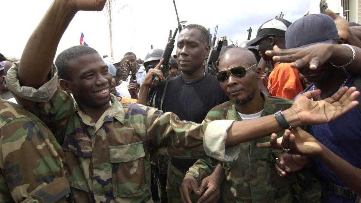 Guy Philippe, left, one of the rebel leaders of the Resistance Front, was in Gonaives after an armed revolt in 2002. Philippe was arrested in 2017 by DEA agents and Haiti’s anti-drug brigade outside of a Port-au-Prince radio station on drug-trafficking charges in the United States.