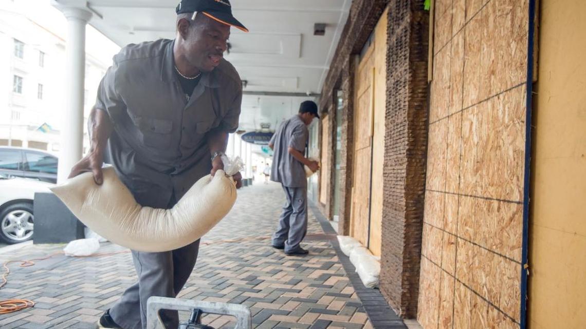 Perry Williams, 47, left, and Alaric Nixon, 28, place sandbags on the storefront of Diamond's International store, in preparation for the arrival of hurricane Joaquin in Nassau, Bahamas on Oct. 1, 2015. Joaquin unleashed heavy flooding as it roared through sparsely populated islands in the eastern Bahamas as a Category 4 storm.