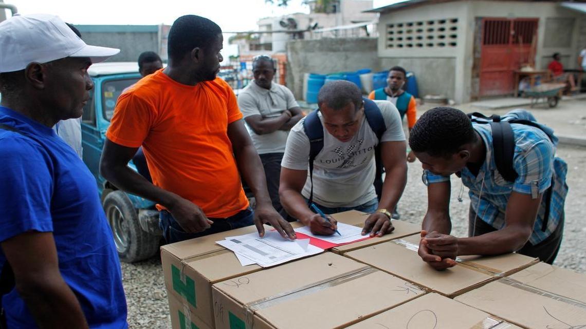 Workers count boxes of electoral material in a polling station in Port-au-Prince, Haiti, Saturday, Nov. 19, 2016. Sunday's voters will choose a president, with the top two finishers going to a Jan. 29 runoff, as well as senators and members of the Chamber of Deputies.