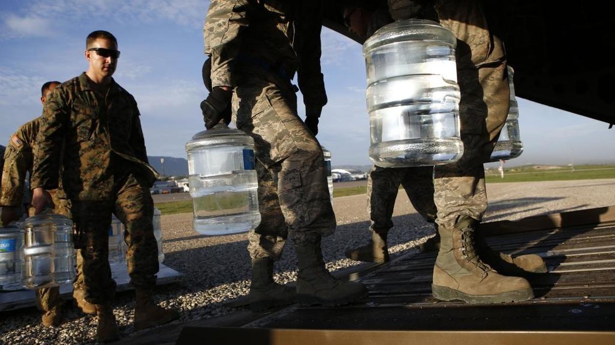 U.S. military troops load jugs of drinking water into a helicopter at the airport in Port-au-Prince Haiti, Friday, Oct. 14, 2016. As part of their ongoing aid delivery flights, two U.S. military helicopters on Friday ferried USAID drinking water and saline to the remote town of Anse d'Hainault, which has seen a spike in cholera cases after suffering severe damage from Hurricane Matthew.
