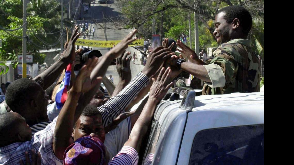 
Guy Philippe, one of the rebel leaders of the Resistance Front drove into Port-au-Prince along with his men on March 1, 2004 after President Jean-Bertrand Aristide left the country. He was greeted on the street of Port-au-Prince by thousands of people.
