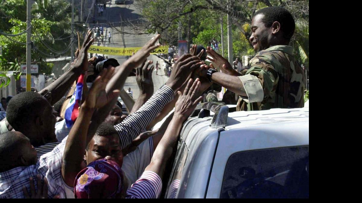 
Guy Philippe, one of the rebel leaders of the Resistance Front drove into Port-au-Prince along with his men on March 1, 2004 after President Jean-Bertrand Aristide left the country. He was greeted on the street of Port-au-Prince by thousands of people.
