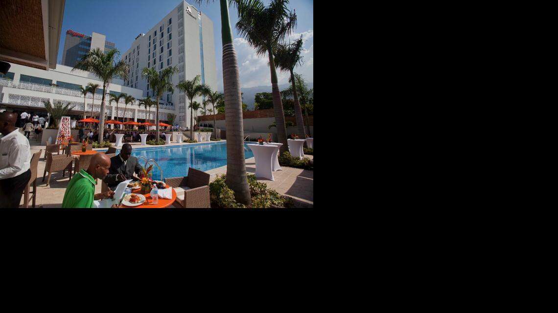 
People eat near the pool at the new Marriott hotel after the hotel's opening ceremony in Port-au-Prince, Haiti, Tuesday, Feb. 24, 2015. Haiti's fourth international-branded hotel opened Tuesday in what backers of the project and officials hope will be a spur to further economic development in the impoverished country. 
