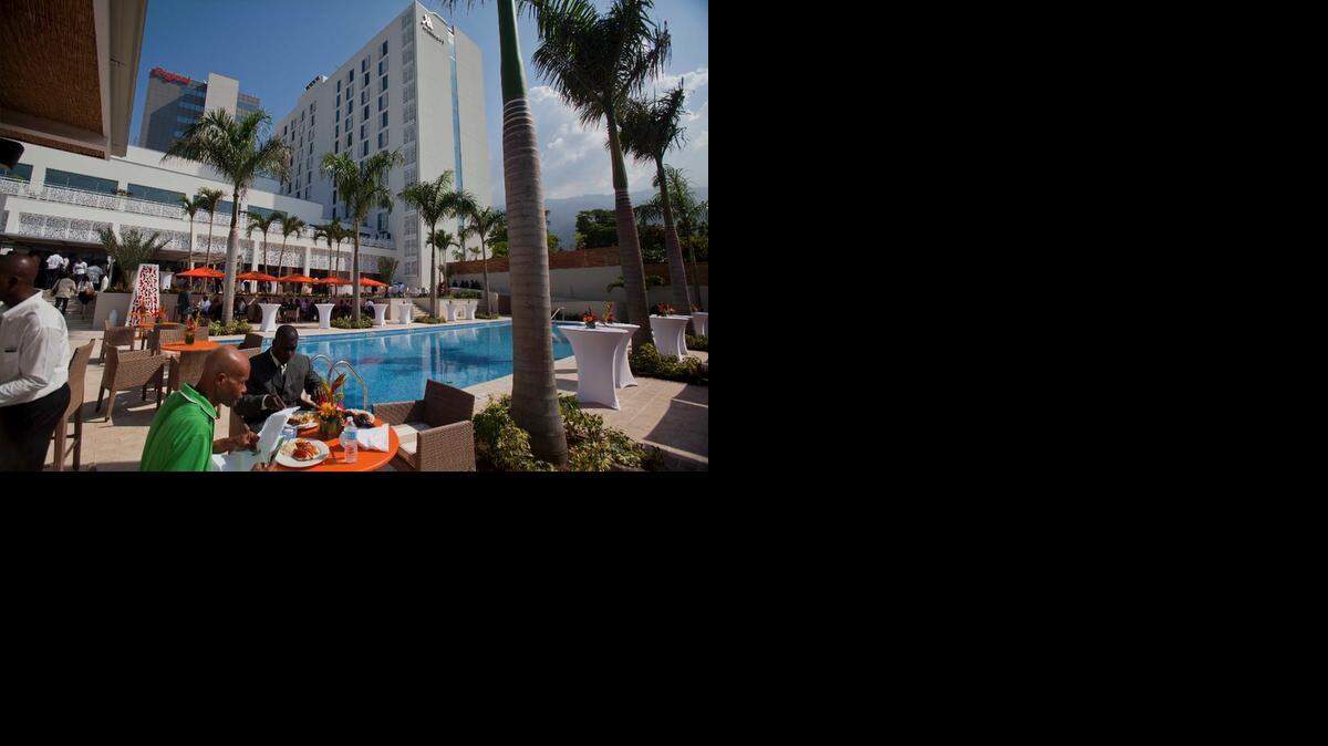 
People eat near the pool at the new Marriott hotel after the hotel's opening ceremony in Port-au-Prince, Haiti, Tuesday, Feb. 24, 2015. Haiti's fourth international-branded hotel opened Tuesday in what backers of the project and officials hope will be a spur to further economic development in the impoverished country. 
