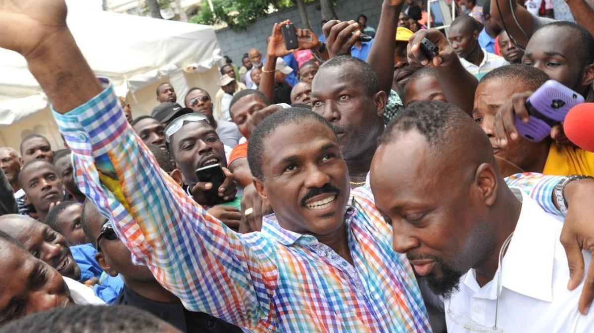 Haiti presidential candidate Jude Celestin (left) with hip hop artist Wyclef Jean after Celstin voted in the Oct. 25 first round presidential elections.