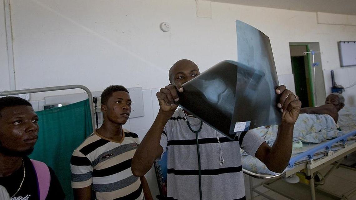 Dr. Jackson Michelet looks at the x-ray of Louis Jean Claude at the Hospital Saint Antoine of Jeremie, Haiti in 2016.