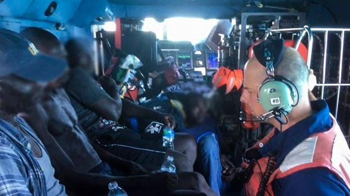 A Coast Guard helicopter takes 15 Haitian migrants to Matthew Town, Bahamas for medical treatment.