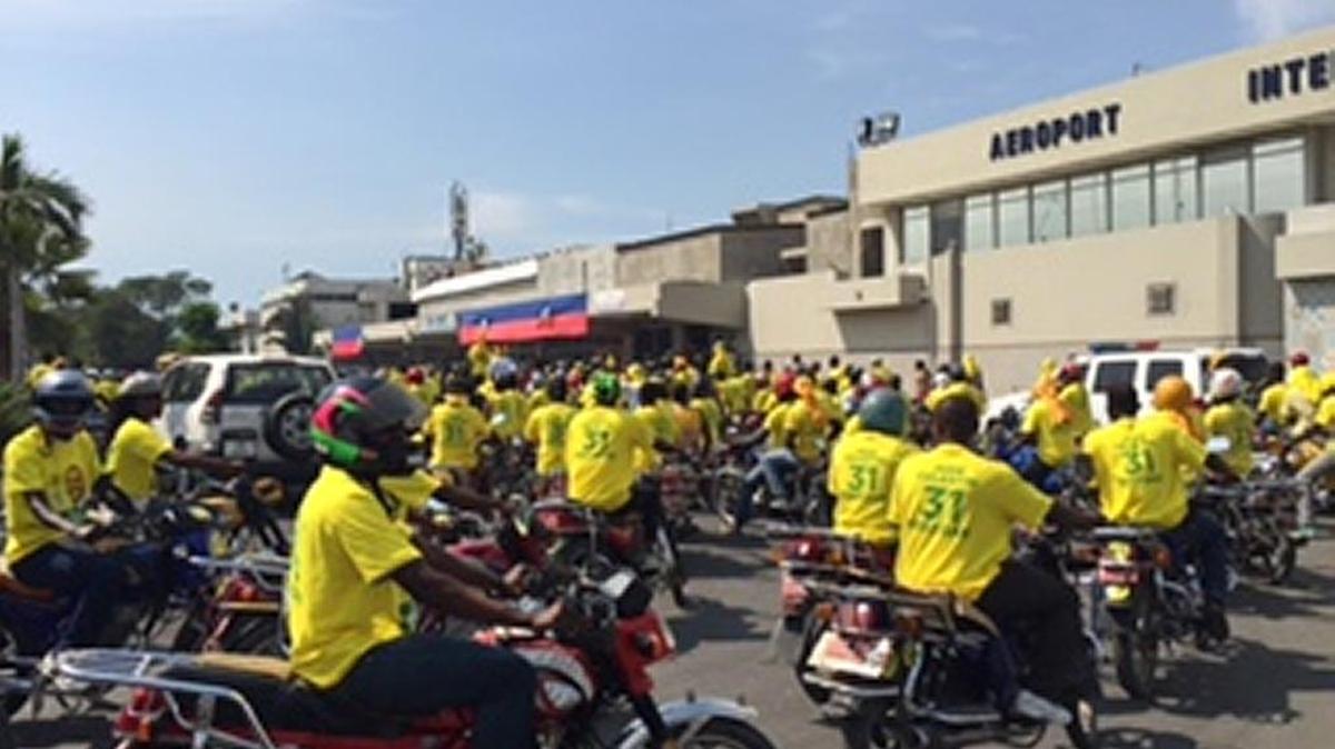 A motorcade greets Haiti-born hip-hop artist Wyclef Jean as he arrived in Port-au-Prince on Friday.