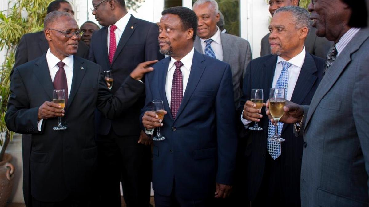 Haiti's interim President Jocelerme Privert, left, speaks with the new interim Prime Minister Fritz Jean during the reception following Jean's induction ceremony at the National Palace in Port-au-Prince, Haiti, Friday, Feb. 26, 2016. Jean, an economist and former governor of Haiti's central bank, joins the interim government which is expected to last 120 days as it prepares to hold a postponed runoff election on April 24.