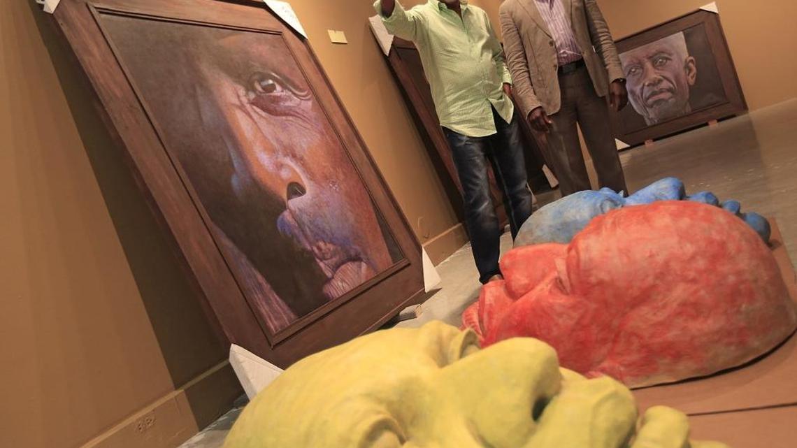 Haitian artist Jean-Claude Legagneur is photographed inside MOCA with North Miami Mayor Dr. Smith Joseph, right, as he installs his one-man show, "Faces of Freedom," as part of Black History Month celebration.
